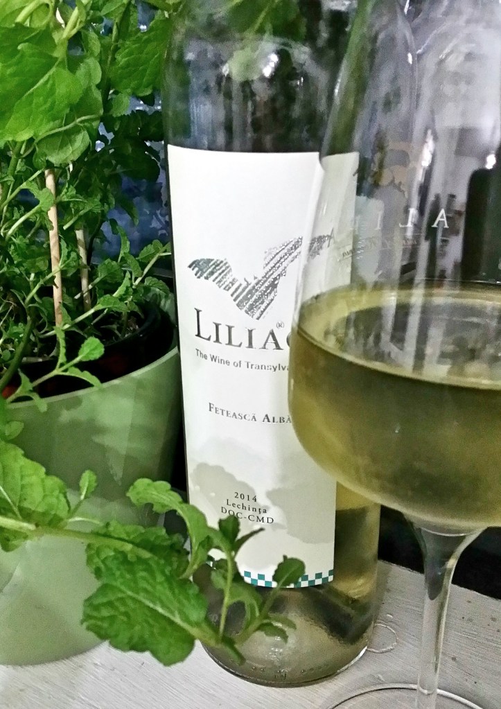  Feteasca Alba 2014. Si e greu de gasit vreun repros, dar ma voi stradui:) Temperatura de servire, pentru inceput, e importanta: prea rece, si vinul va parea aspru si intepator sub presiunea aciditatii inalte; prea cald, si poate deveni plat si obositor. Zona optima zic ca e totusi destul de larga, undeva intre 12 si 15 grade (ceva mai mai mult decat cele 10 grade recomandate pe contraeticheta), ceea ce permite totusi ca vinul sa fie servit in conditii rezonabile, fara sa fiti tot timpul cu ochii pe termometru si frapiera cu gheata. Dar atunci cand nimeriti acest sweet spot de temperatura, vinul e perfect echilibrat, cu o aciditate sanatoasa, ardeleneasca, ce sustine o constructie aromatica ceva mai intensa decat ne-am obisnuit de la acest soi -clasicele note de ierboase-amarui, completate insa frumos de flori de camp, si usoare impresii tropicale, de lamaie zaharisita. Cu un corp zvelt si degraba curgator, n-as vrea sa ramaneti totusi cu impresia ca e un vin usurel, buna doar de sete. Are ceva consistenta si fibra care sa-l faca potrivit pentru preparate ceva mai aventuroase -tartine cu pasta de peste afumat, de exemplu